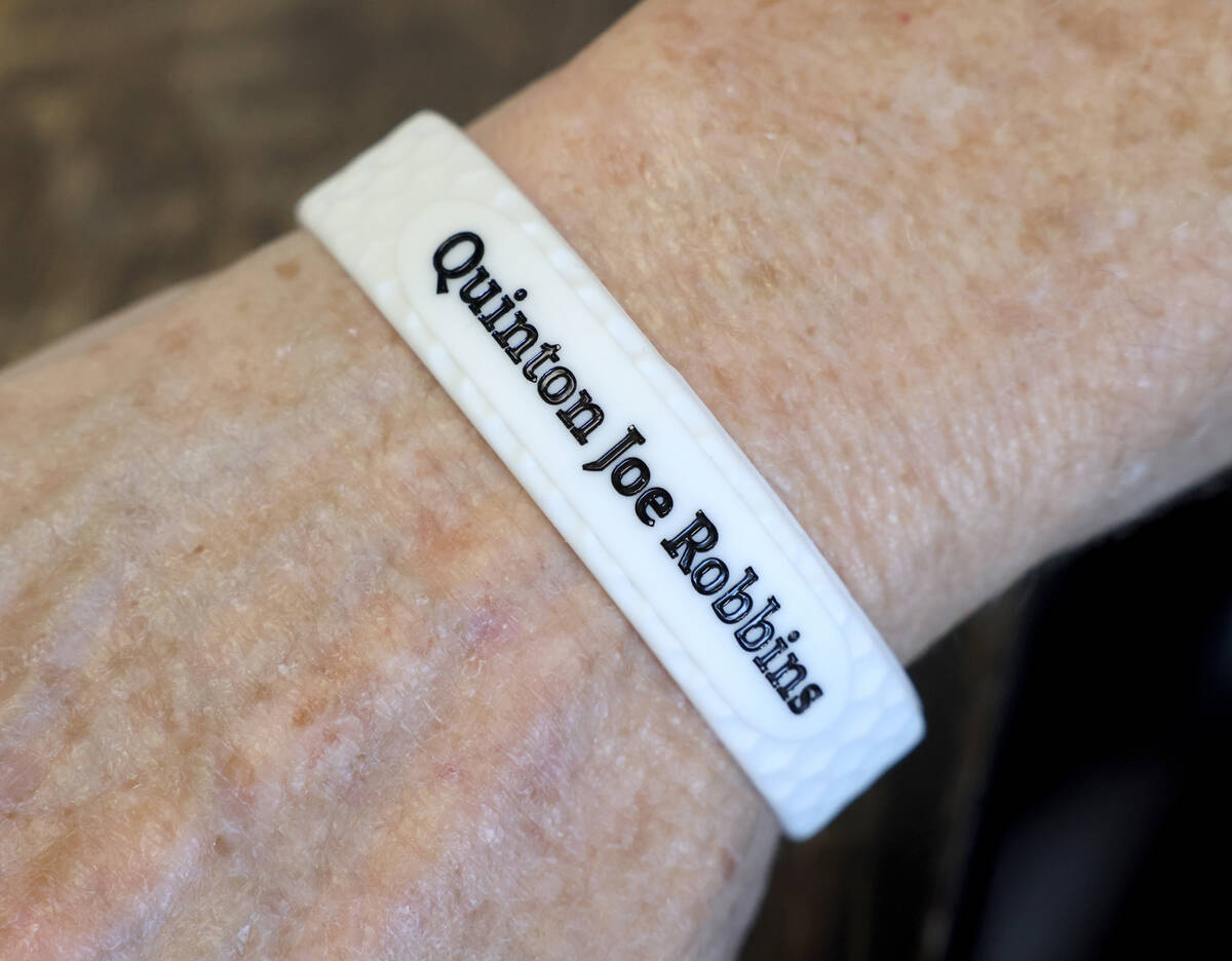 A guest shows her bracelet during a fundraiser for the Quinton Robbins Playitforward Foundation ...