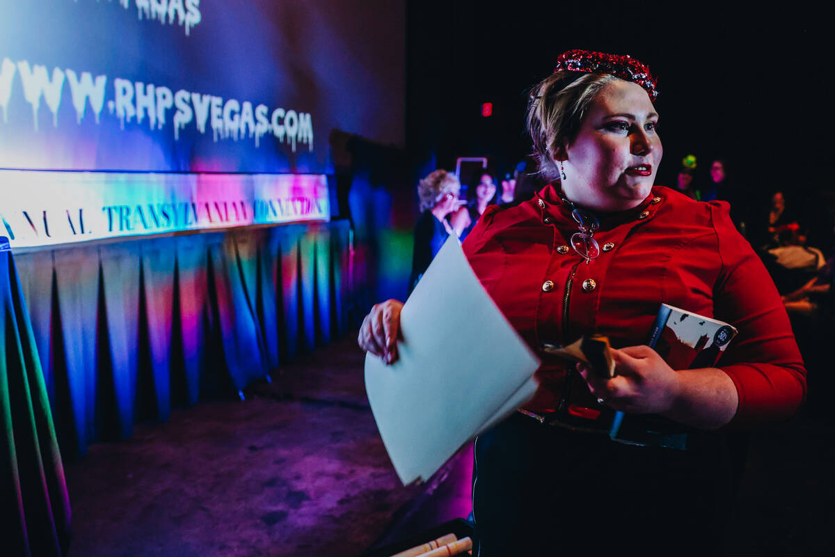 Emma C., a “Rocky Horror Picture Show” cast member, hands out certificates to fir ...
