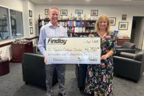 Tyler Corder, Findlay Automotive’s chief financial officer, presents a check to Paulette Ande ...