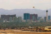 A jet begins an approach for landing at Nellis Air Force Base with the skyline beyond it on Fri ...