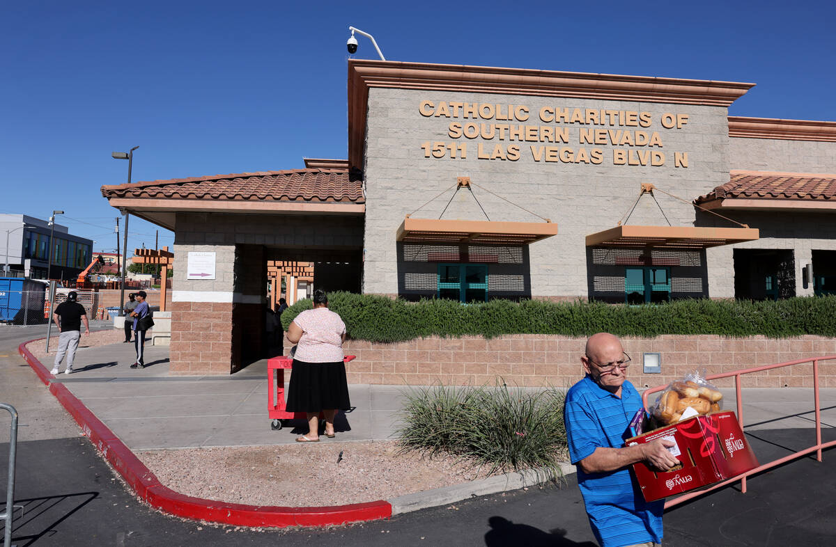 Elias Lopez Pineda picks up food pantry items at Catholic Charities of Southern Nevada in Las V ...