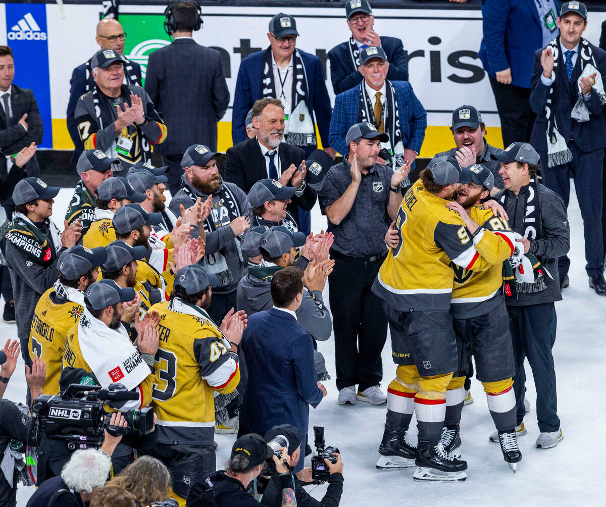 Golden Knights center Jack Eichel (9) and teammates congratulate right wing Jonathan Marchessau ...