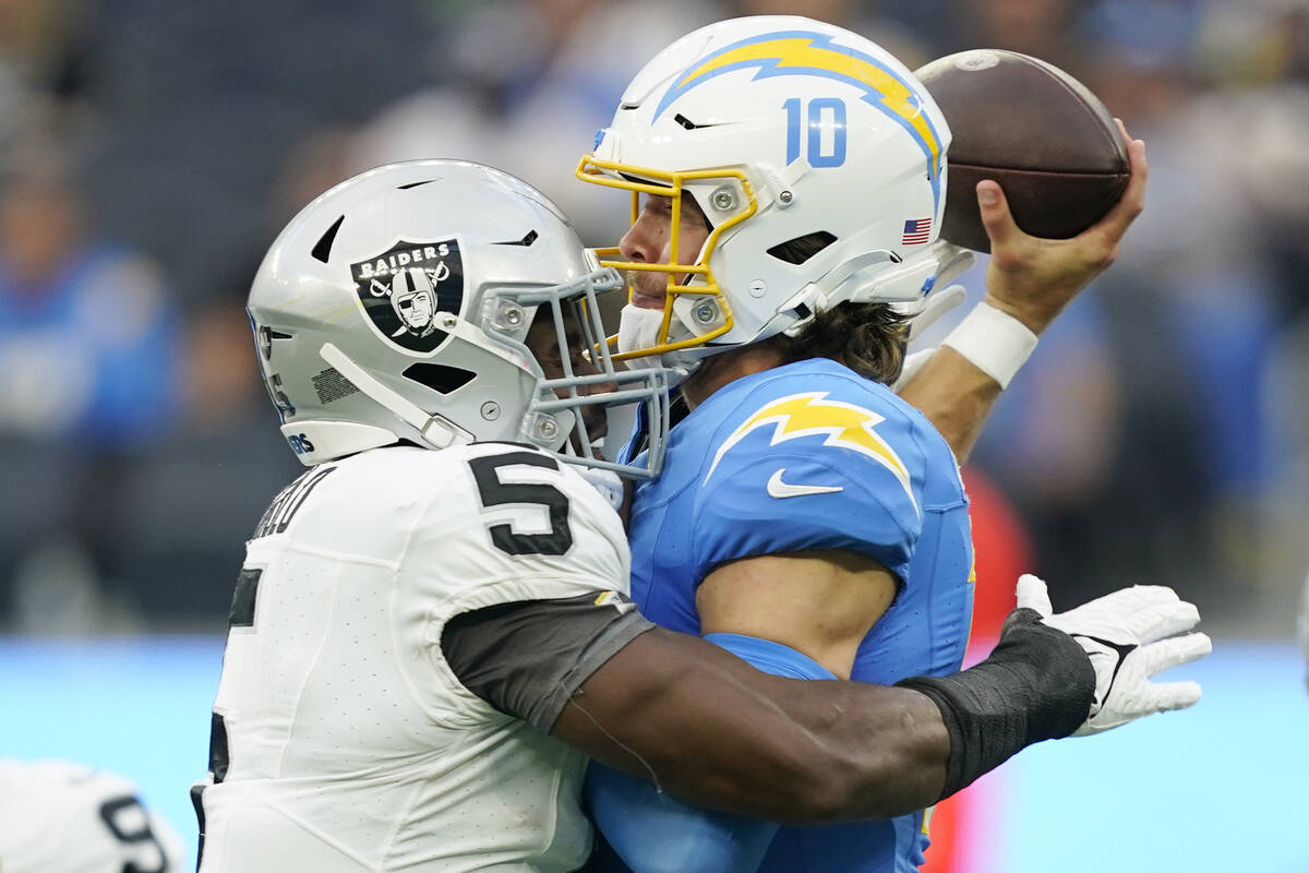 Los Angeles Chargers quarterback Justin Herbert (10) throws under pressure from Las Vegas Raide ...