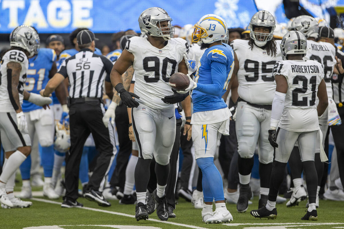 Los Angeles Chargers wide receiver Keenan Allen (13) interacts with Raiders defensive tackle Je ...