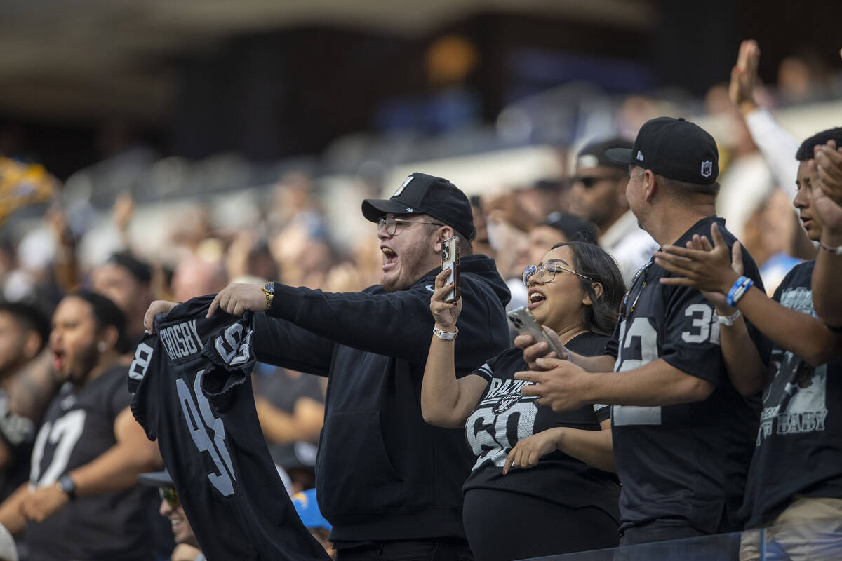 Raiders fans cheer during the second half an NFL game against the Los Angeles Chargers on Sunda ...