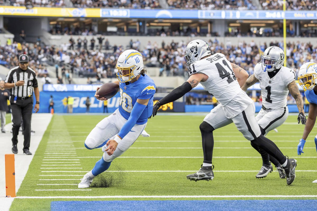 Los Angeles Chargers quarterback Justin Herbert (10) runs for a touchdown against the Las Vegas ...