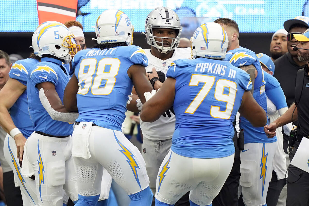 Las Vegas Raiders defensive tackle Jerry Tillery, center, is confronted by Los Angeles Chargers ...