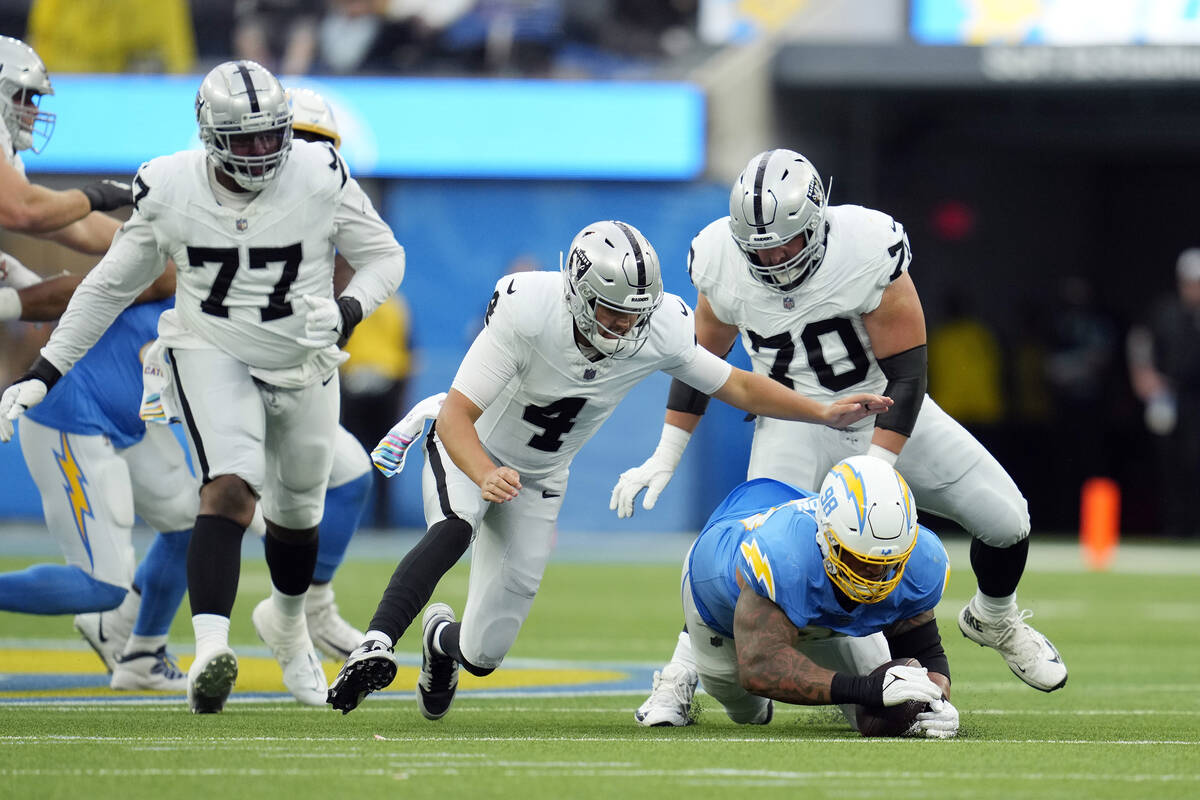 Los Angeles Chargers defensive tackle Austin Johnson, bottom right, recovers a fumble by Las Ve ...