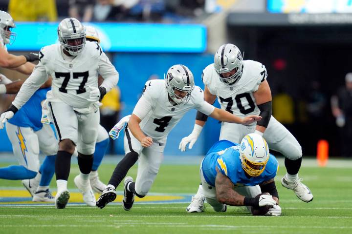Los Angeles Chargers defensive tackle Austin Johnson, bottom right, recovers a fumble by Las Ve ...