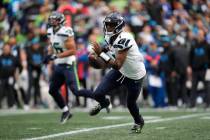 Seattle Seahawks quarterback Geno Smith (7) rushes with the ball during an NFL football game ag ...