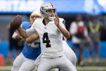 Raiders quarterback Aidan O'Connell (4) looks to throw during the first half an NFL game agains ...