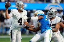 Las Vegas Raiders quarterback Aidan O'Connell (4) throws under pressure from Los Angeles Charge ...