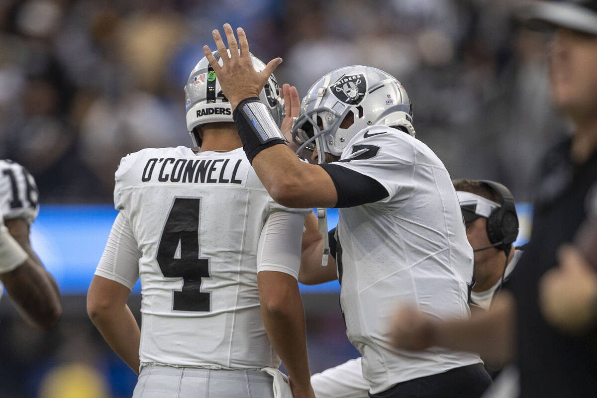 Raiders quarterback Brian Hoyer (7) congratulates quarterback Aidan O'Connell (4) on his touchd ...