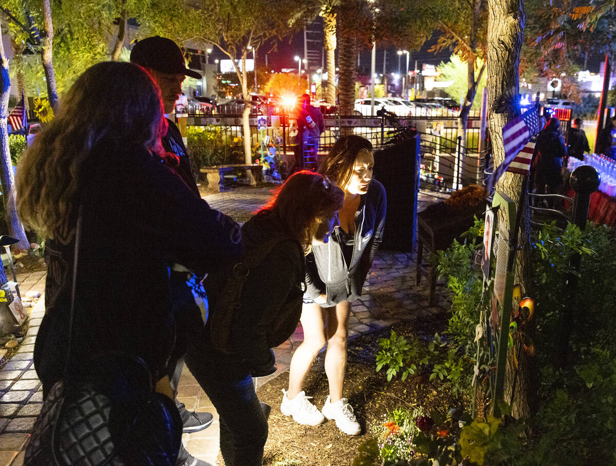 Family members of Cameron Robinson, a shooting victim, visit the Community Healing Garden prior ...