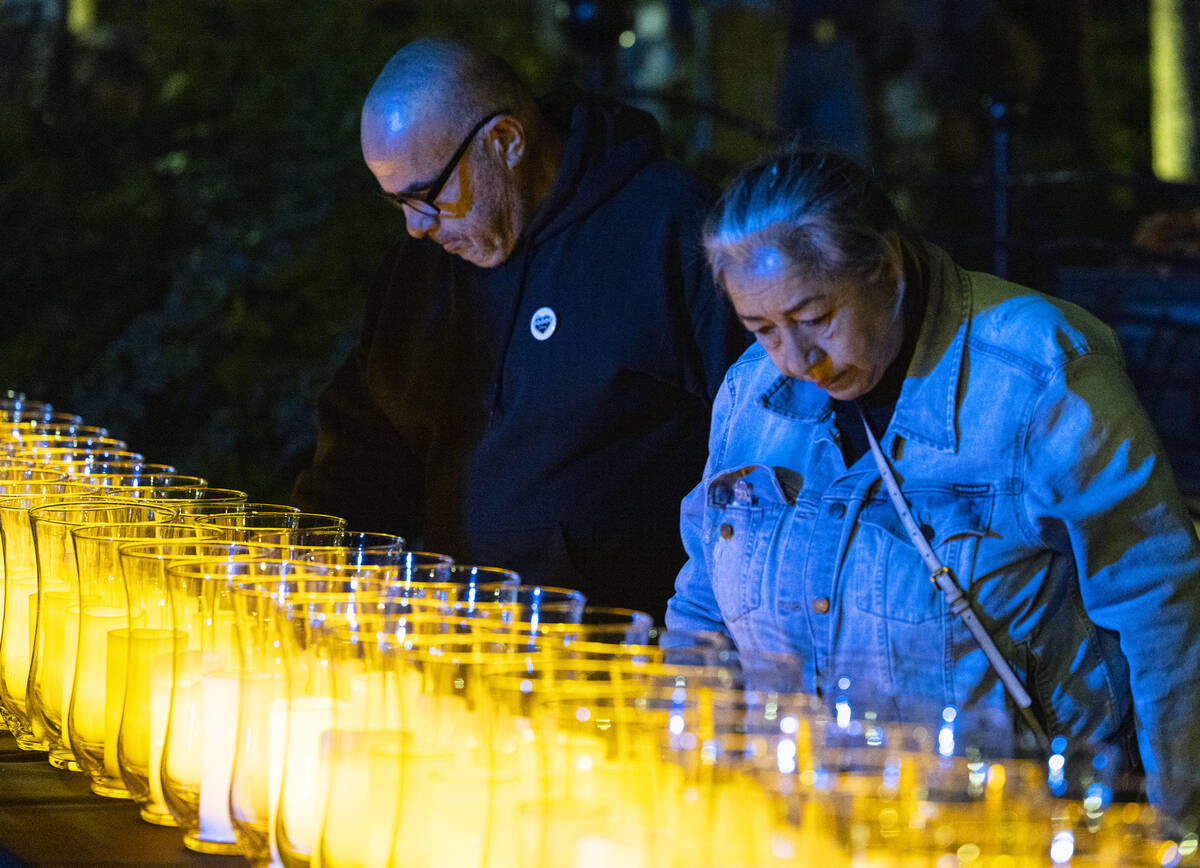 People stand around lit candles after Mayor Carolyn Goodman and David Riggleman, Las Vegas comm ...
