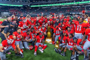 UNLV players and coaches celebrate their win in the Ninth Island Showdown against Hawaii follow ...