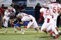 Truckee High School football player Graham Christian (18) tackles Moapa Valley's Sean McConnell ...