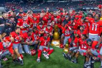 UNLV players and coaches celebrate their win in the Ninth Island Showdown against Hawaii follow ...