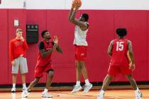 UNLV Rebels forward Karl Jones (22) shoots for the basket as guards Kalib Boone (10) and Luis R ...