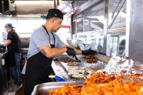 Rudi Larios prepares tacos inside Casa del Sabor food truck at the corner of Bonanza Road and L ...