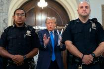 Former President Donald Trump speaks with journalists during a midday break from court proceedi ...