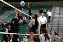 Liberty’s Alex Walker (2) spikes while Palo Verde’s Taylor Mendez, left, and Kari ...