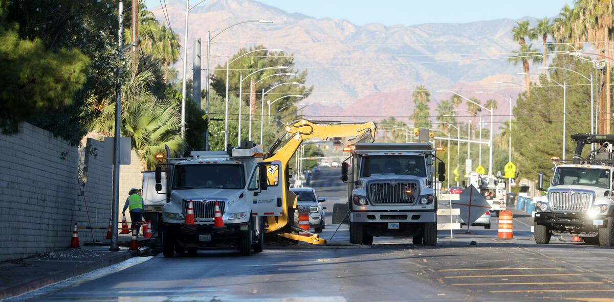 Las Vegas Valley Water District employees work on a water main break on Oakey Boulevard west of ...