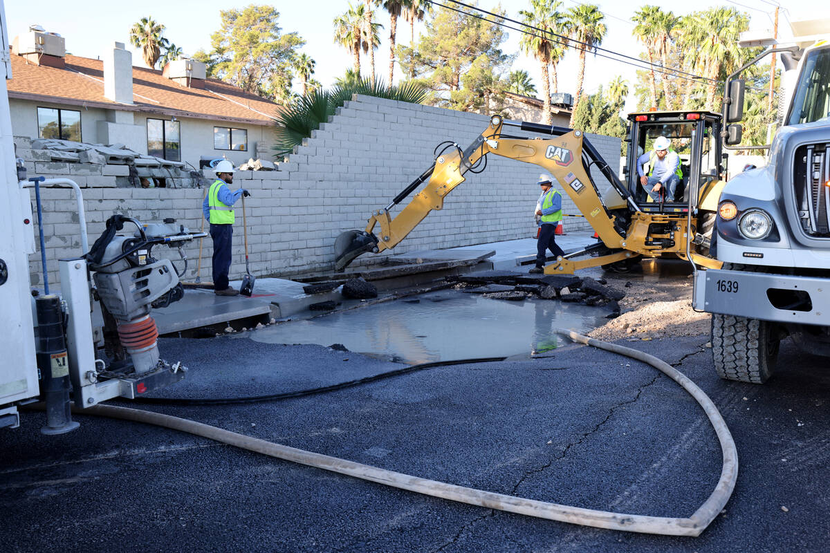 Las Vegas Valley Water District employees work on a water main break on Oakey Boulevard west of ...