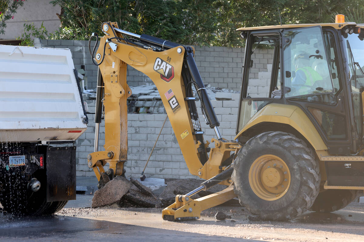 Las Vegas Valley Water District employees work on a water main break on Oakey Boulevard west of ...