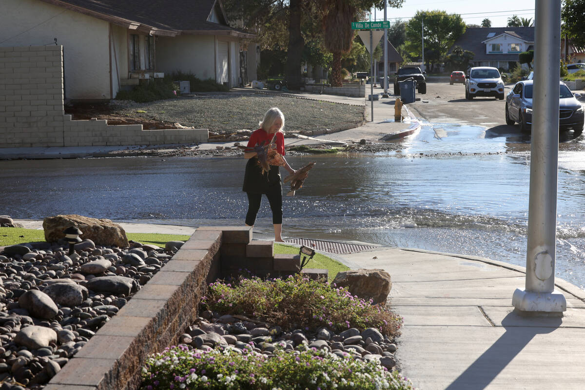 Water is seen on the roadway at Villa De Conde Way and Las Solana Way in Las Vegas on Wednesday ...