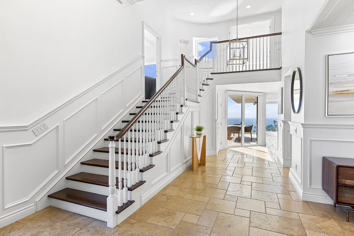 Up the spiral staircase are double doors leading to the vast primary suite. (Marx Real Estate G ...