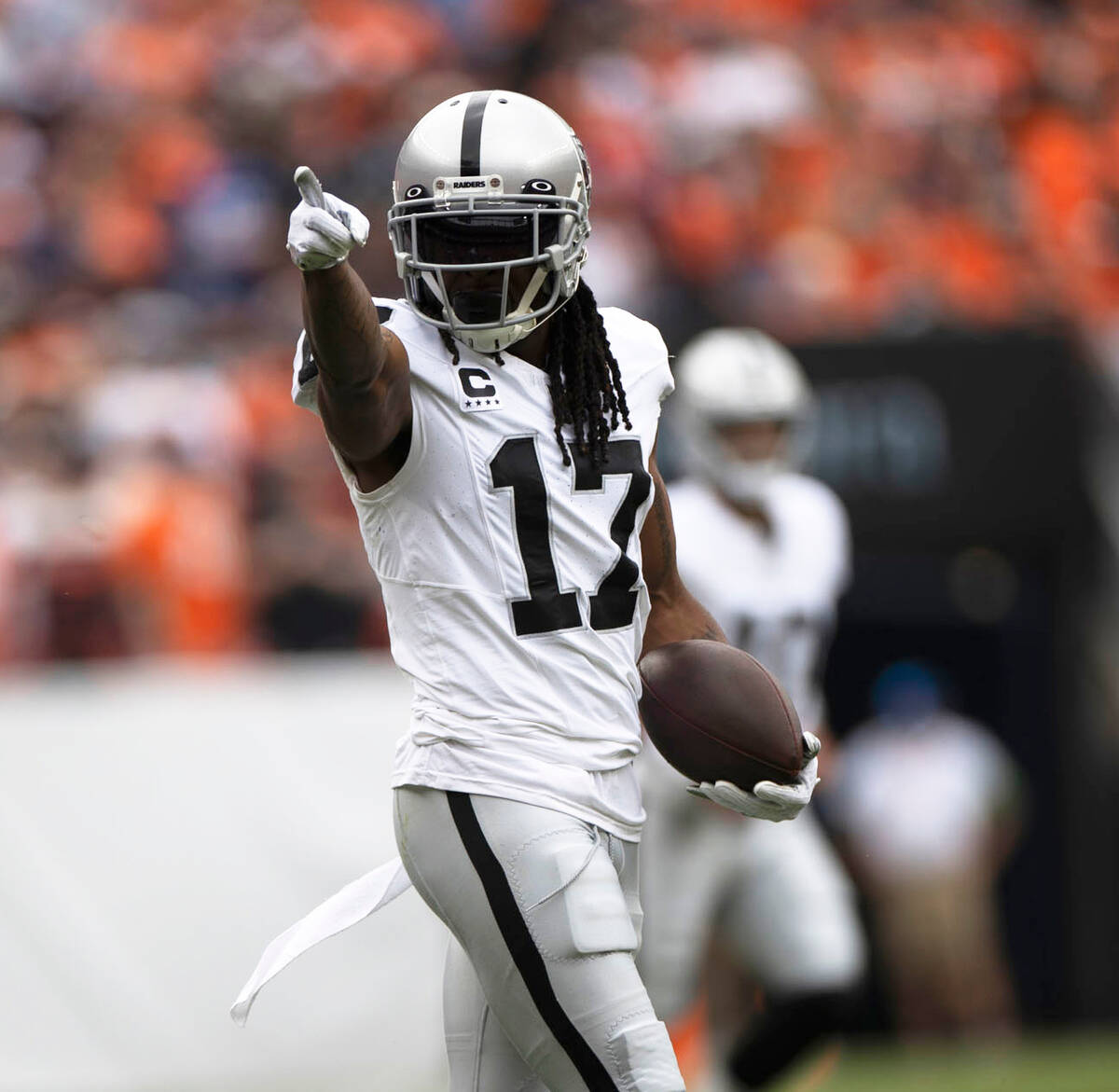 Raiders wide receiver Davante Adams (17) points to signal for a first down during the first hal ...