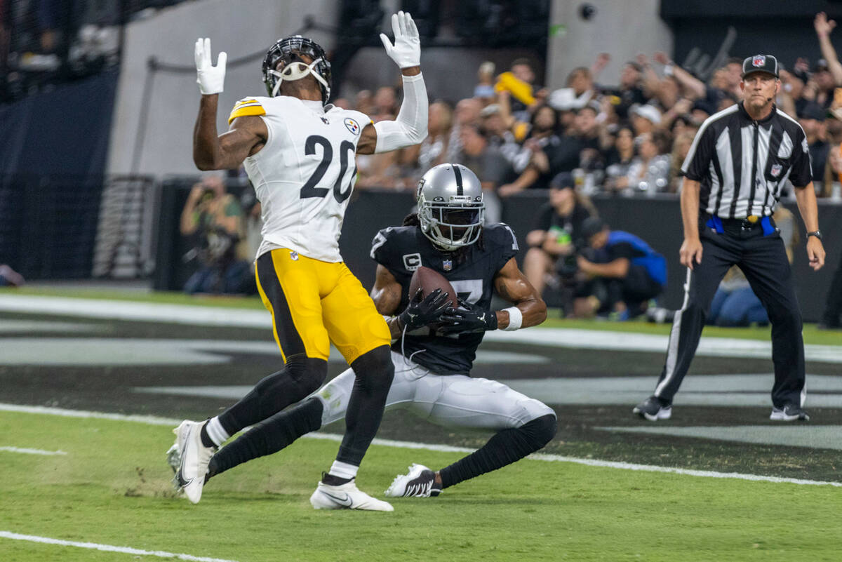 Raiders wide receiver Davante Adams (17) hauls in a touchdown catch with Pittsburgh Steelers co ...