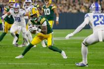 Green Bay Packers wide receiver Romeo Doubs (87) runs after making a catch during an NFL footba ...