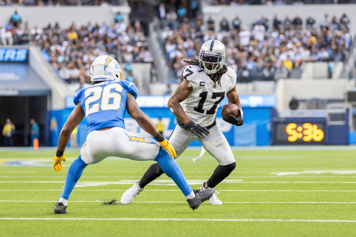 Las Vegas Raiders wide receiver Davante Adams (17) catches a pass and runs against the Los Ange ...