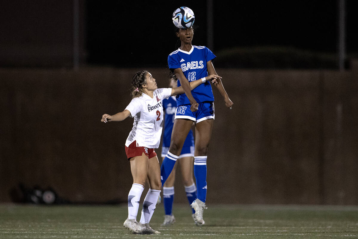 Bishop Gorman midfielder Amiya Warner (12) makes a header over Liberty midfielder Natalie Colli ...