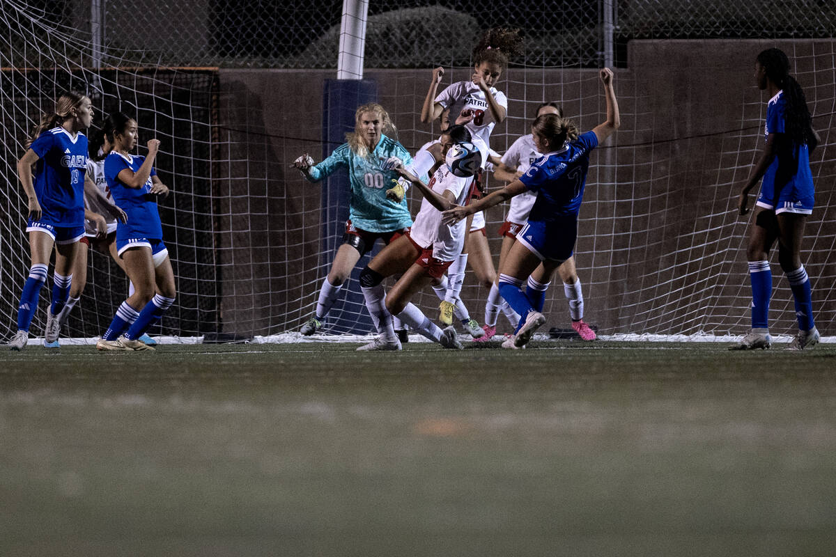 Liberty’s defense stops an attempted goal by Bishop Gorman midfielder Kennedy Herman (7) ...