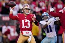 San Francisco 49ers quarterback Brock Purdy (13) passes in front of Dallas Cowboys linebacker M ...
