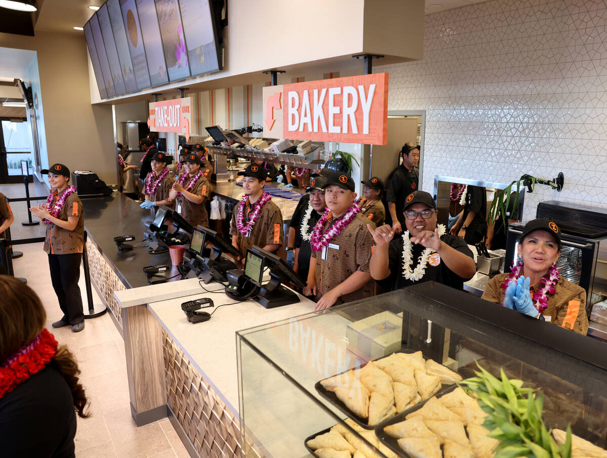 Employees cheer for the first customers during the grand opening of Zippy’s at the corne ...
