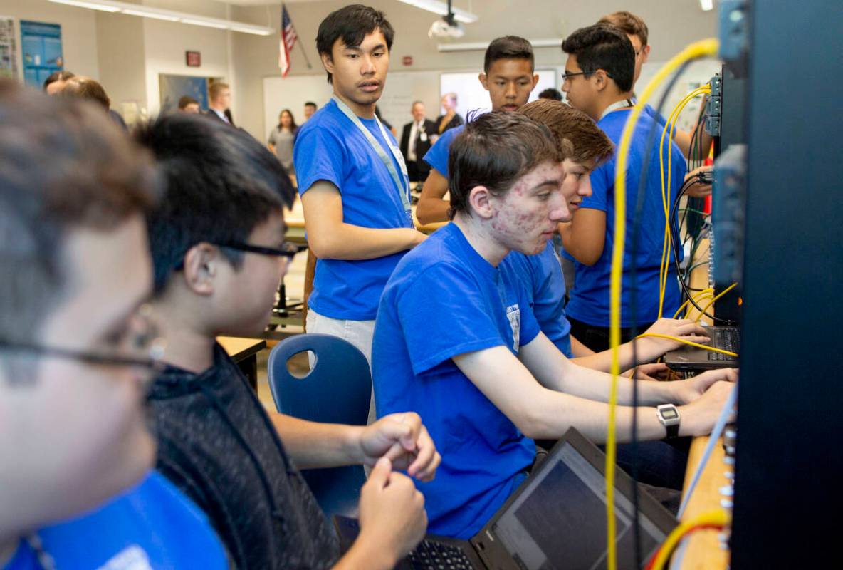 FILE - Computer science juniors work on a project in class during a tour to individuals repres ...