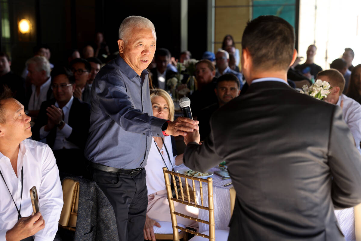 Las Vegas entrepreneur Teddy Liaw, founder of NexRep, right, hands the microphone to Andrew Che ...