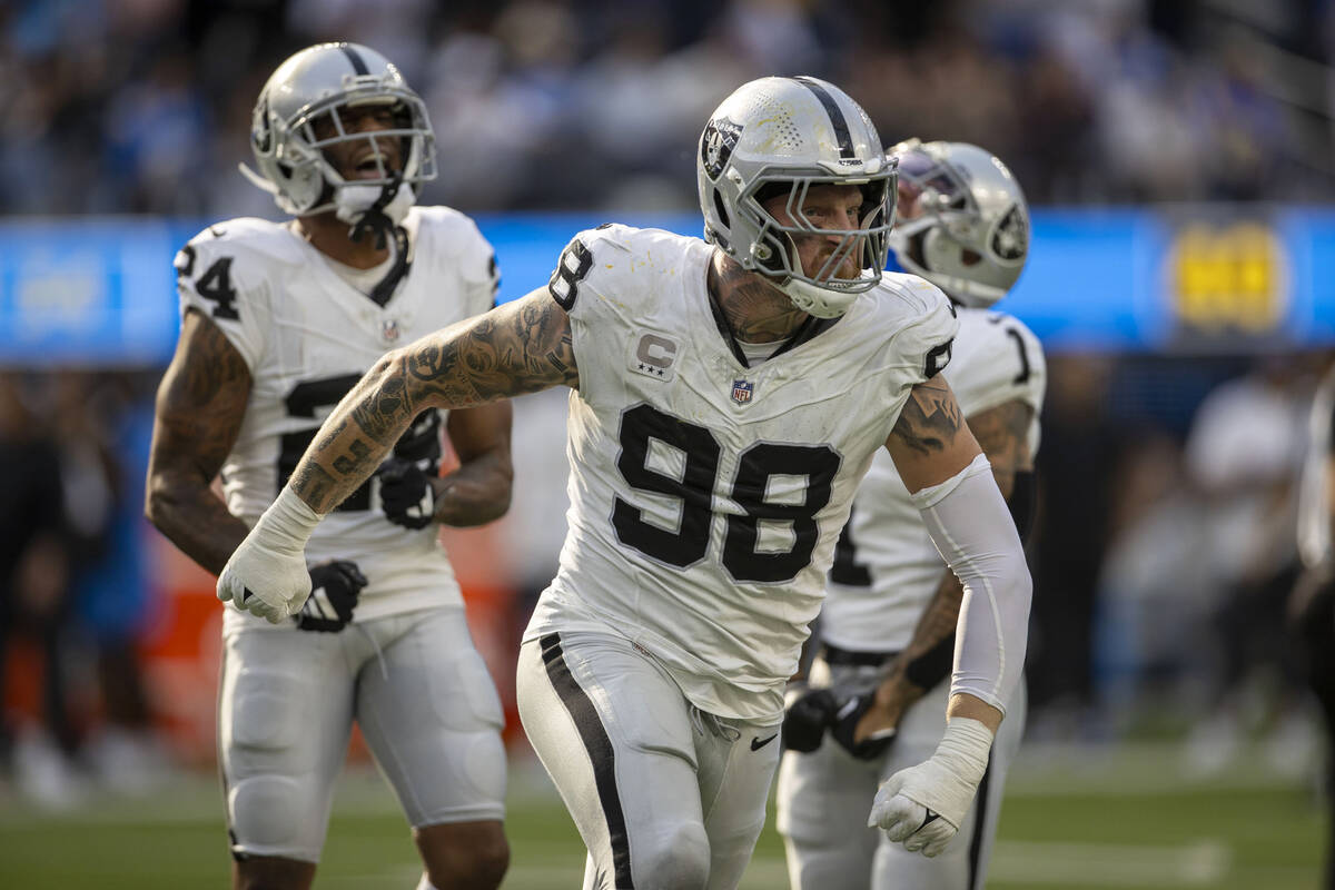 Raiders defensive end Maxx Crosby (98) celebrates a sack of Los Angeles Chargers quarterback Ju ...