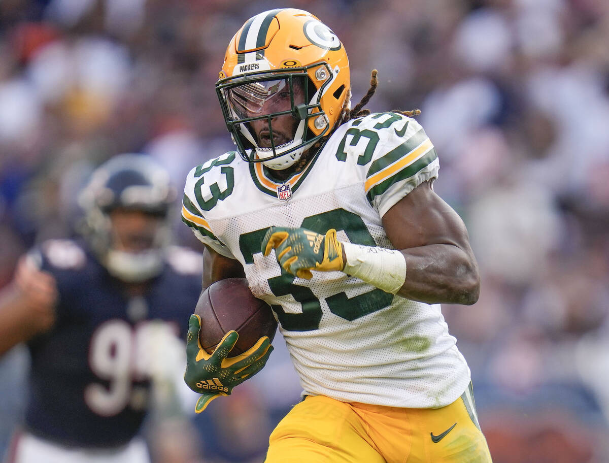 Green Bay Packers running back Aaron Jones (33) runs in a touchdown during the second half of a ...