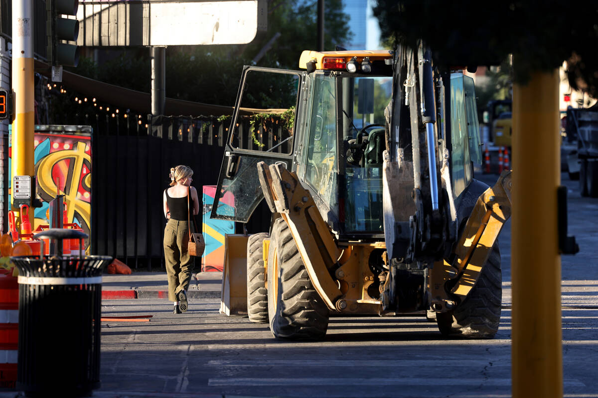 A pedestrian walks on Seventh Street at Carson Avenue in downtown Las Vegas as construction con ...