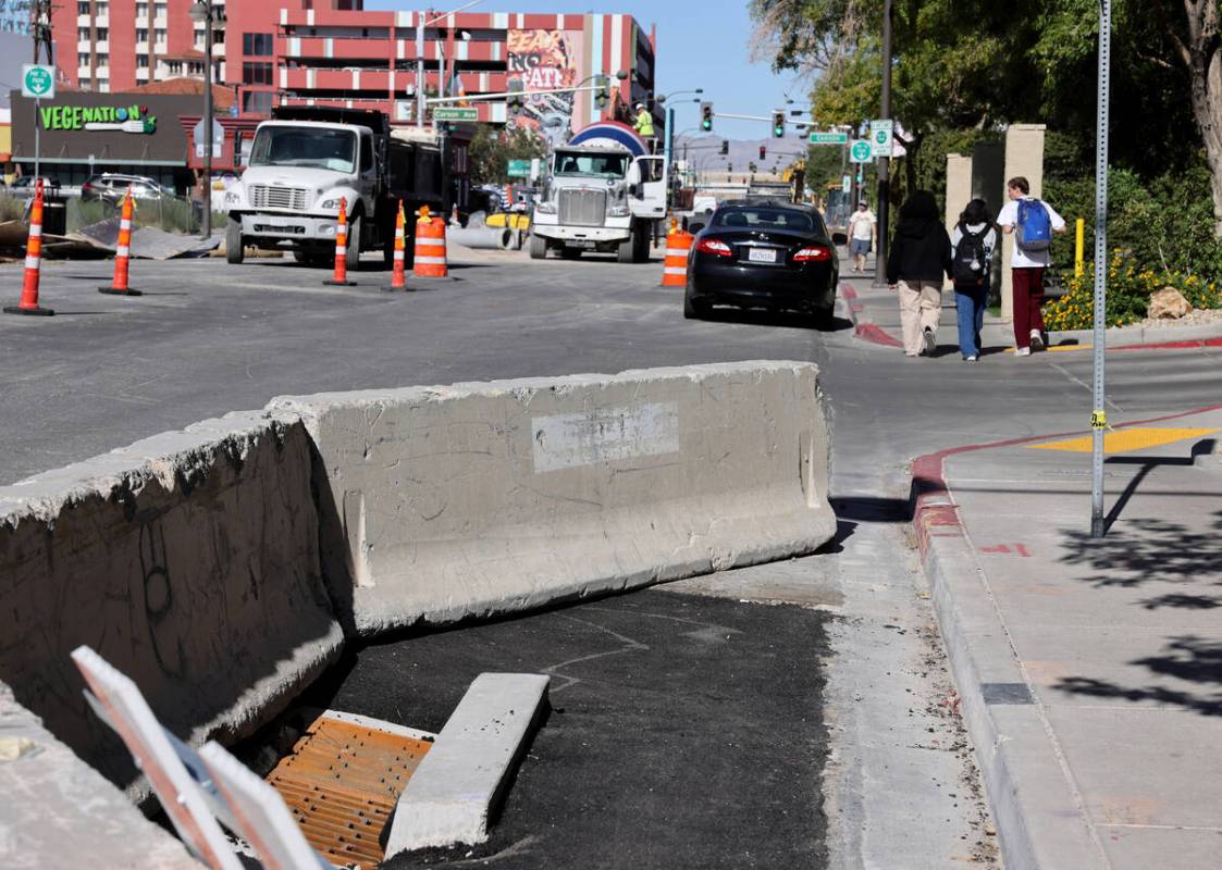 Pedestrians walk on Seventh Street between Bridger and Carson avenues in downtown Las Vegas as ...