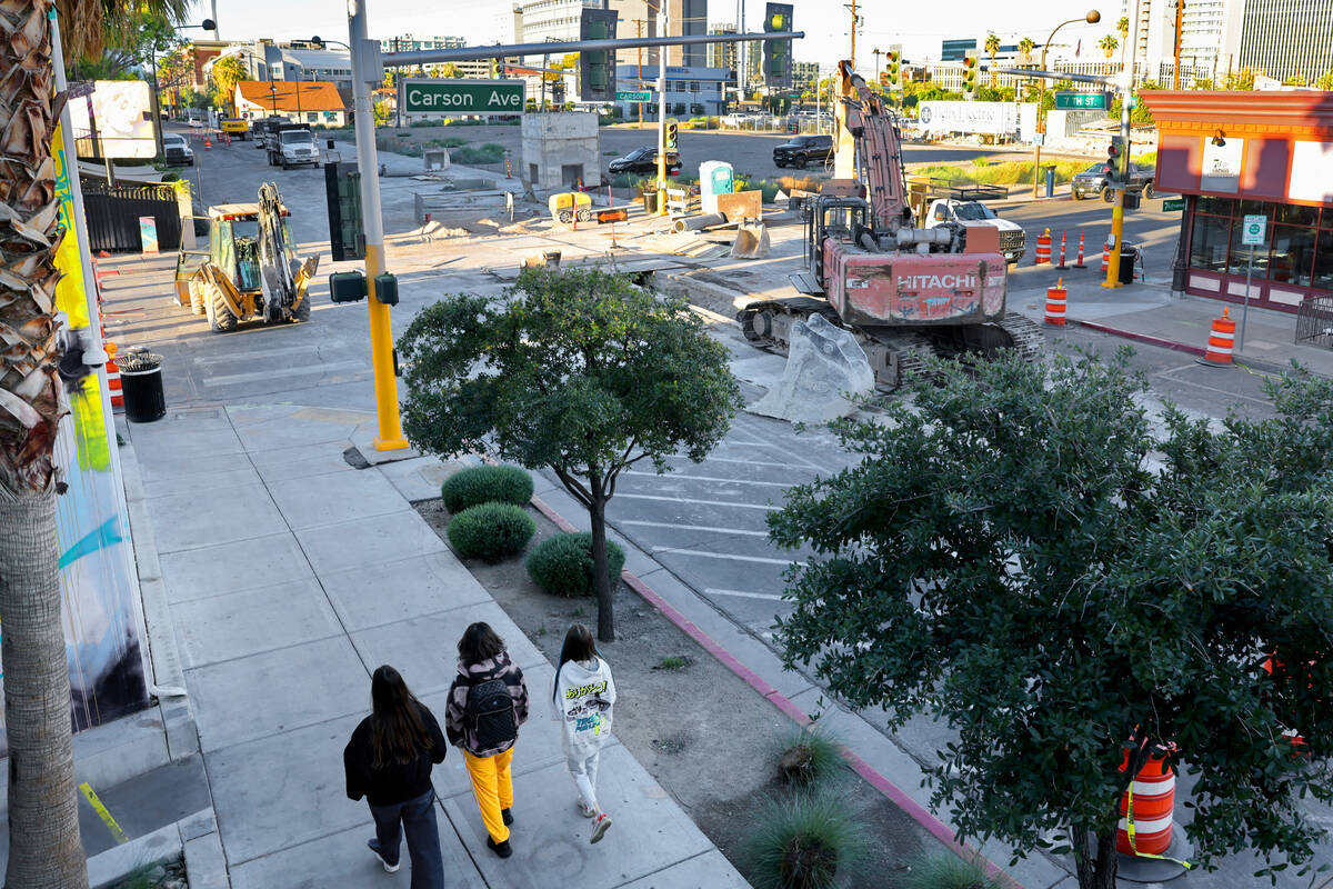 Pedestrians walk on Seventh Street at Carson Avenue in downtown Las Vegas as construction conti ...