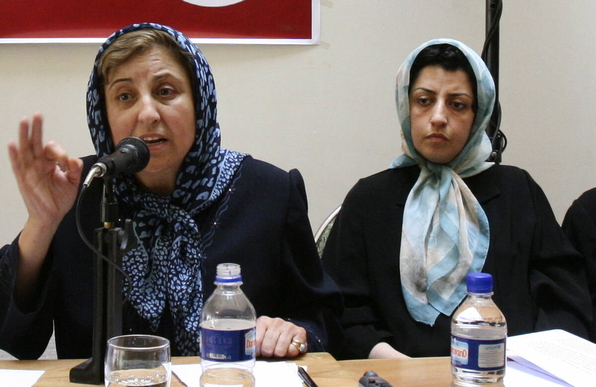Prominent Iranian human rights activist Narges Mohammadi, right, listens to Iranian Nobel Peace ...
