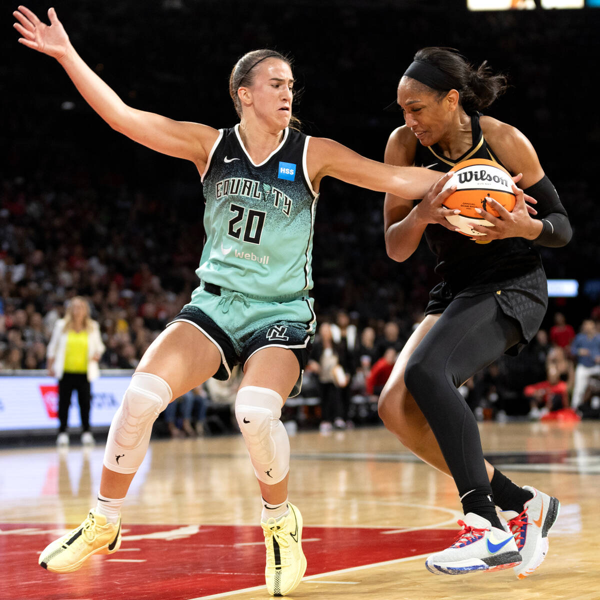 New York Liberty guard Sabrina Ionescu (20) fouls Las Vegas Aces forward A'ja Wilson (22) durin ...