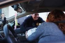 Police officer Deborah Rinkovsky gives away a turkey during a turkey giveaway event hosted by t ...