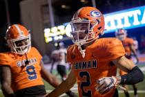 Bishop Gorman wide receiver Audric Harris (2) is congratulated on his touchdown by teammates du ...